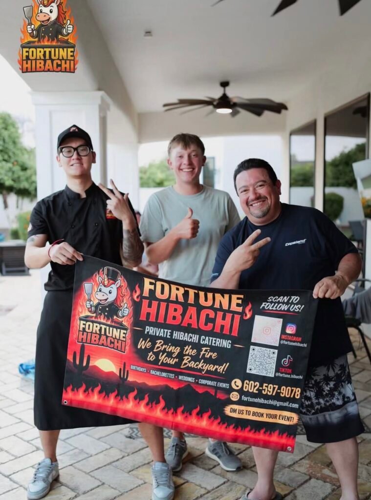 Fortune Hibachi chef and guests holding a party banner