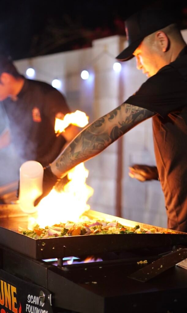 Hibachi chef cooking fried rice and vegetables on the grill