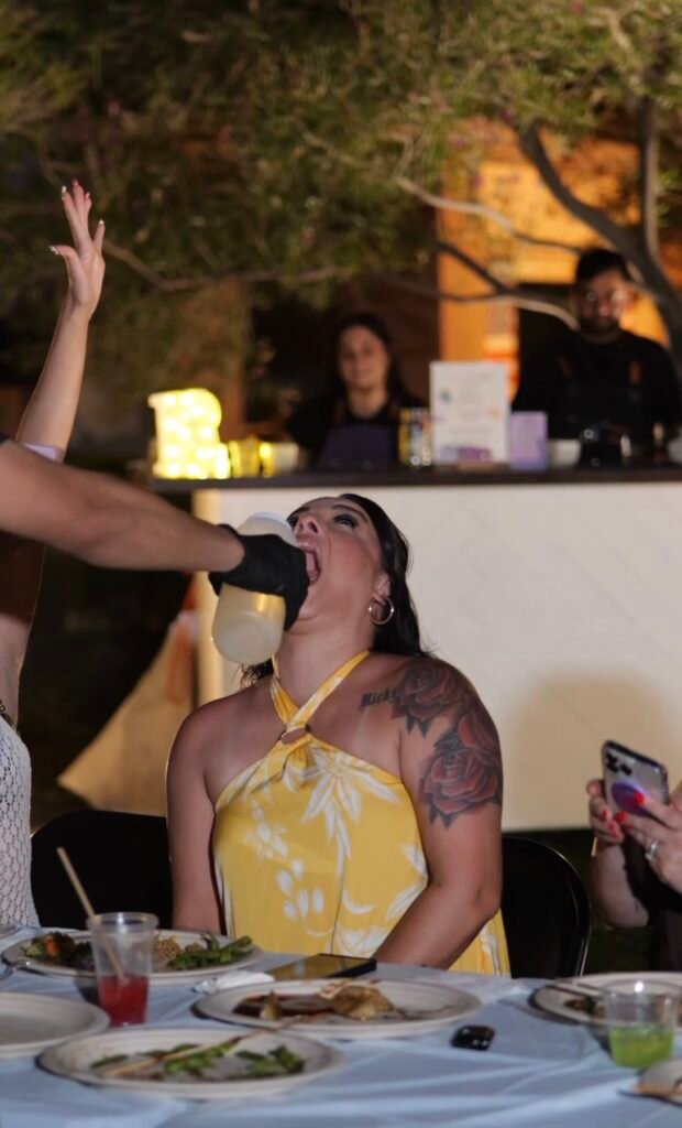 Guest catching a sake pour at the dinner table during a hibachi party