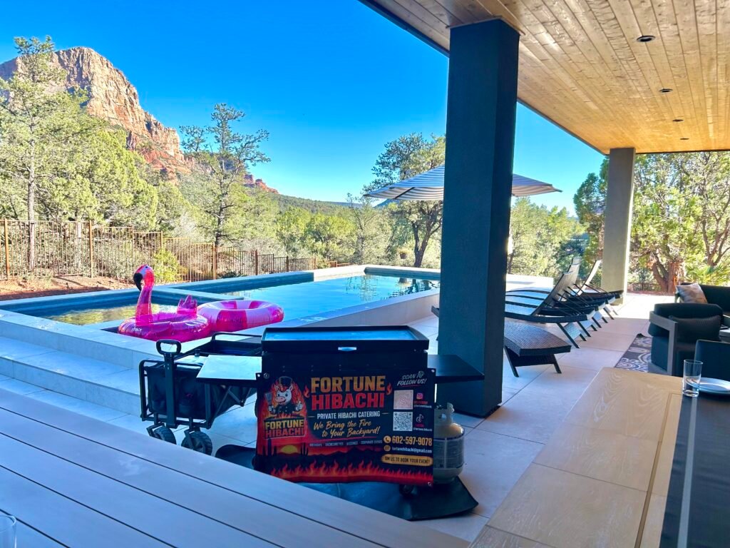 Fortune Hibachi mobile grill set up beside a pool with red rock mountains in the background